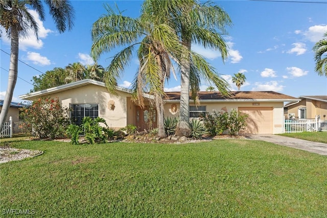 ranch-style home featuring a garage and a front lawn