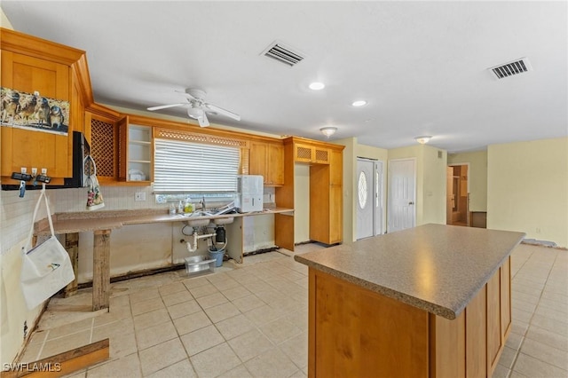 kitchen with tasteful backsplash, light tile patterned floors, and ceiling fan