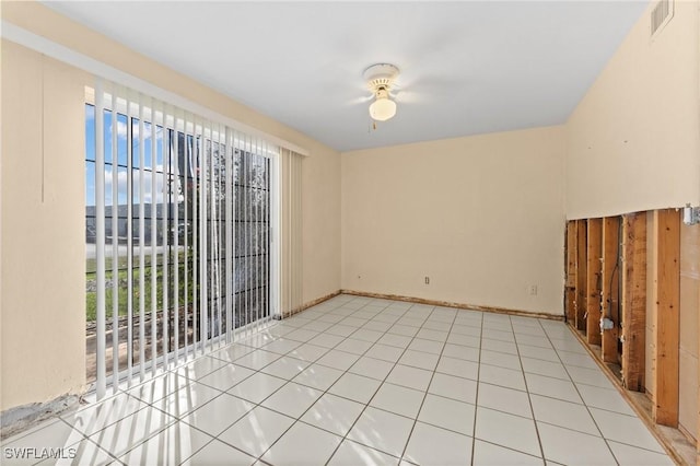 empty room featuring light tile patterned floors and a healthy amount of sunlight