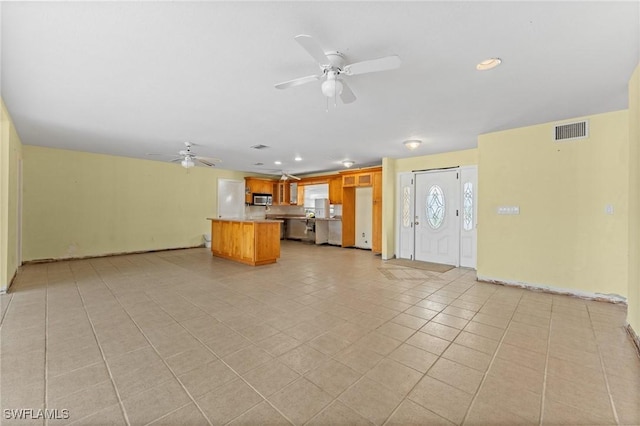 unfurnished living room with ceiling fan and light tile patterned flooring