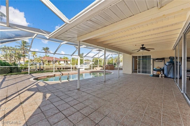 view of pool featuring a lanai, a patio area, and ceiling fan