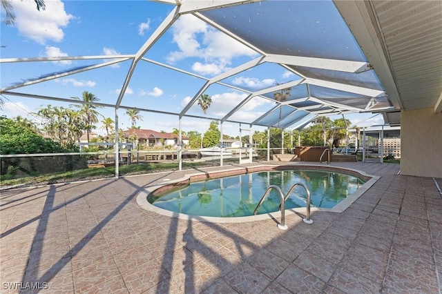 view of pool featuring a patio, glass enclosure, and a jacuzzi