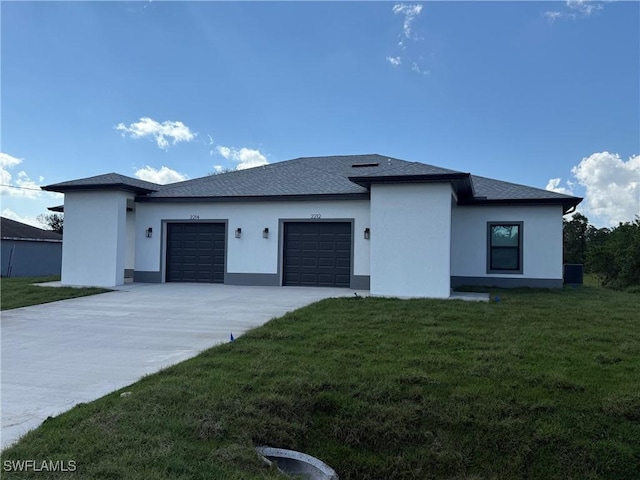 view of front facade with a garage, a shingled roof, concrete driveway, a front lawn, and stucco siding