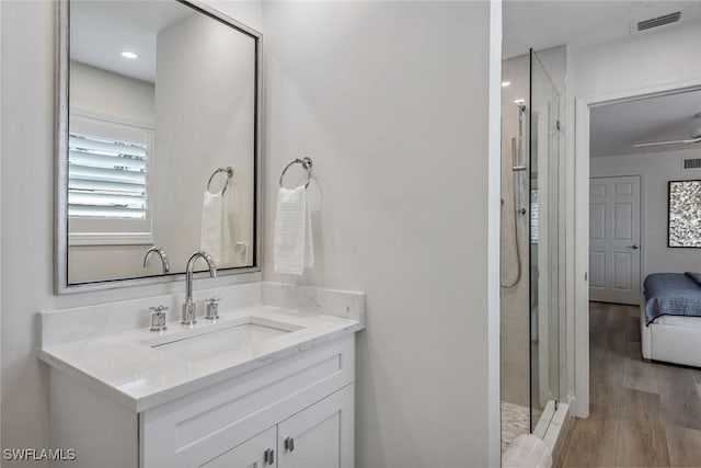 bathroom with vanity, a shower, and wood-type flooring