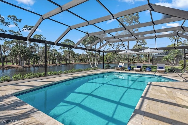 view of swimming pool featuring a patio area, a water view, and glass enclosure