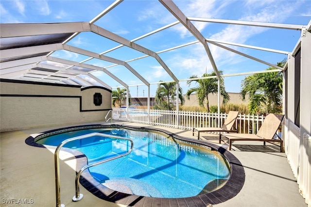 view of swimming pool with a patio area and glass enclosure