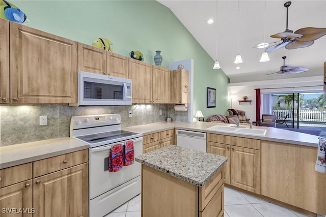 kitchen with sink, tasteful backsplash, lofted ceiling, light tile patterned floors, and white appliances