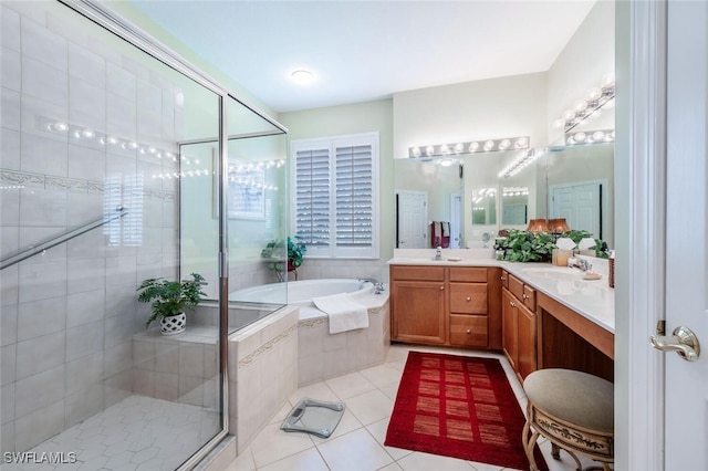 bathroom featuring a garden tub, tile patterned floors, a sink, and a shower stall