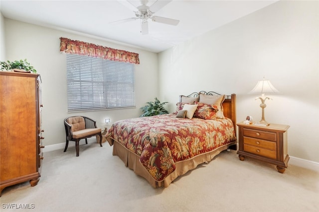 bedroom featuring light colored carpet, ceiling fan, and baseboards