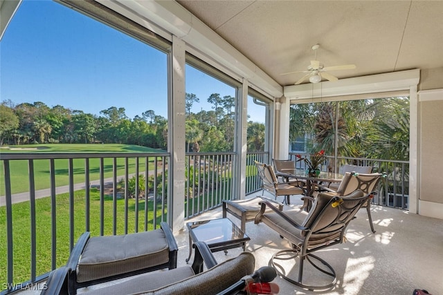 sunroom / solarium featuring a ceiling fan