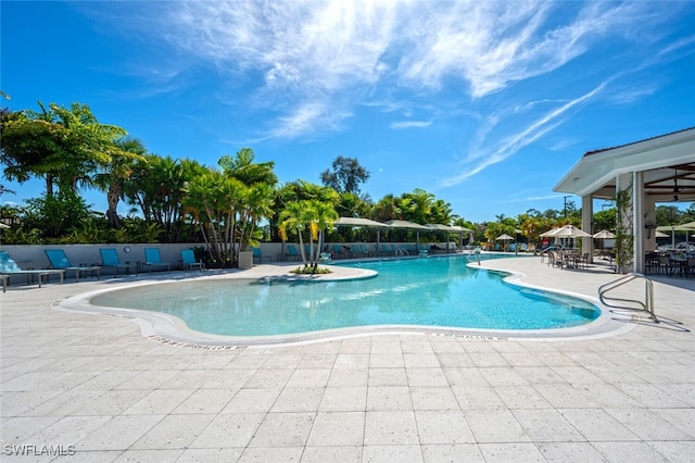 community pool featuring a patio and fence