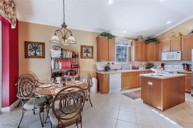 kitchen with crown molding, white appliances, a sink, and decorative backsplash