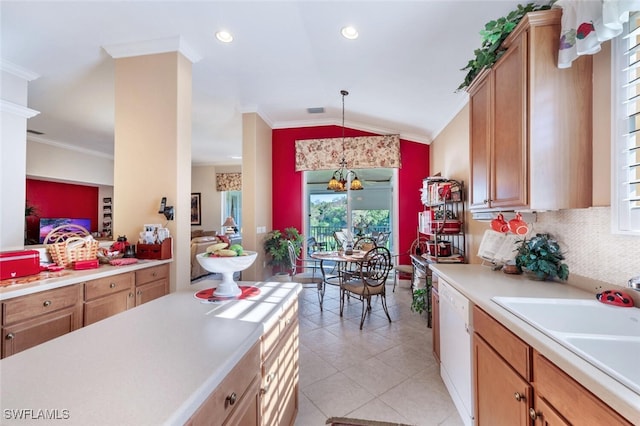 kitchen featuring crown molding, light countertops, white dishwasher, and a sink