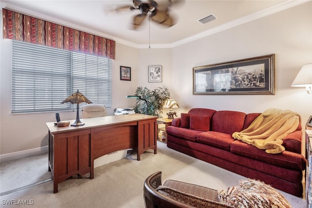 carpeted office featuring a ceiling fan, baseboards, visible vents, and crown molding