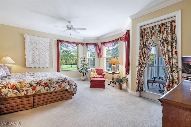 carpeted bedroom featuring baseboards, a ceiling fan, and crown molding