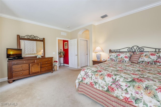 bedroom featuring light colored carpet, visible vents, and crown molding