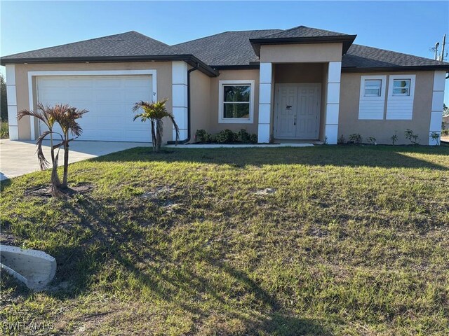 view of front of house featuring a garage and a front yard