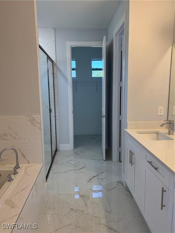 bathroom featuring vanity and shower with separate bathtub