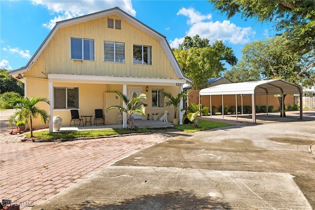 view of front of home with a carport and a porch