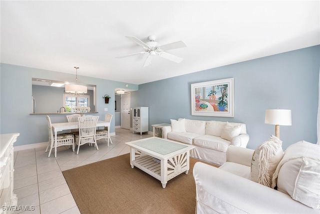 living room featuring ceiling fan and light tile patterned floors