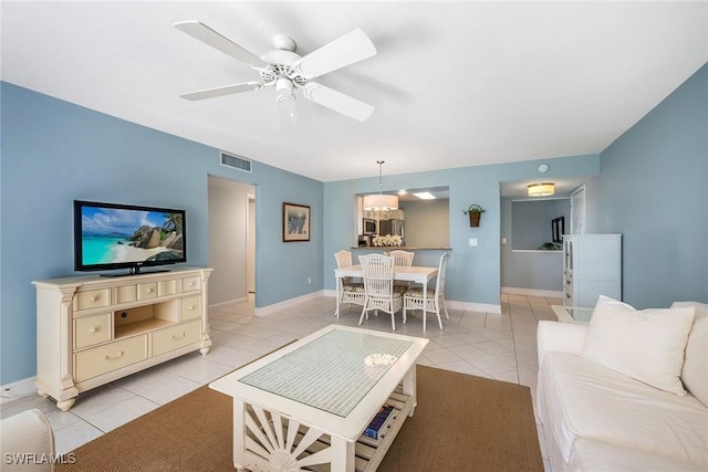 living room with ceiling fan and light tile patterned floors