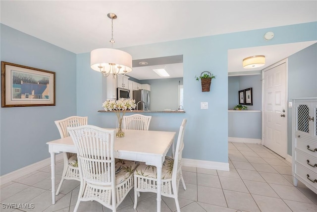 dining area with light tile patterned flooring and an inviting chandelier