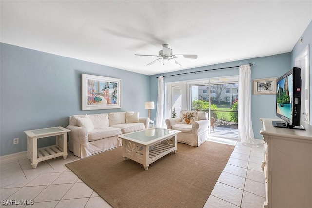 living room with ceiling fan and light tile patterned flooring