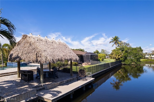 dock area with glass enclosure and a water view