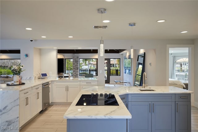 kitchen with visible vents, black electric cooktop, white cabinetry, a sink, and recessed lighting