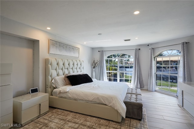 bedroom featuring visible vents, access to outside, light wood-style flooring, and recessed lighting