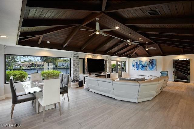 living room with vaulted ceiling with beams, light wood-style flooring, wood ceiling, and a wealth of natural light