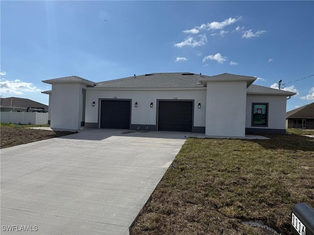 view of front of home featuring a garage and a front lawn