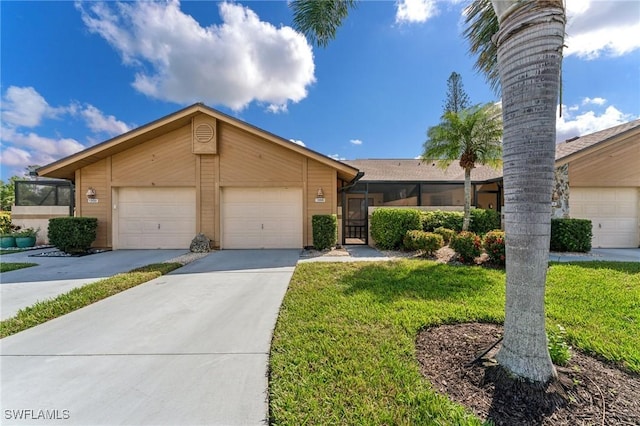 ranch-style home featuring a garage and a front lawn