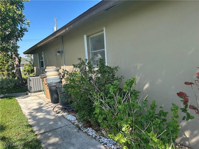 view of property exterior featuring central AC and a patio area