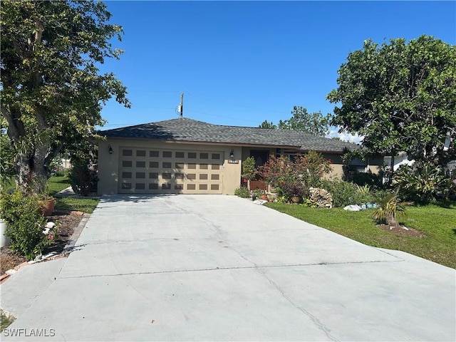 view of front of house with a garage and a front yard