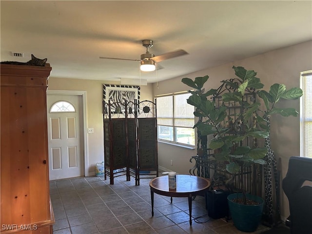 interior space with ceiling fan