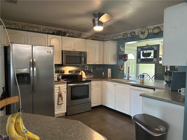 kitchen featuring sink, ceiling fan, white cabinetry, stainless steel appliances, and kitchen peninsula