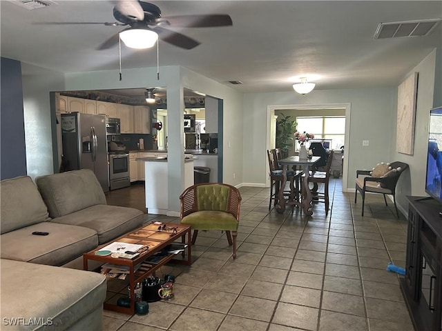 tiled living room featuring ceiling fan