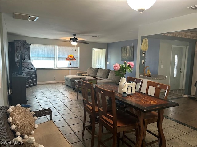 tiled dining room featuring ceiling fan