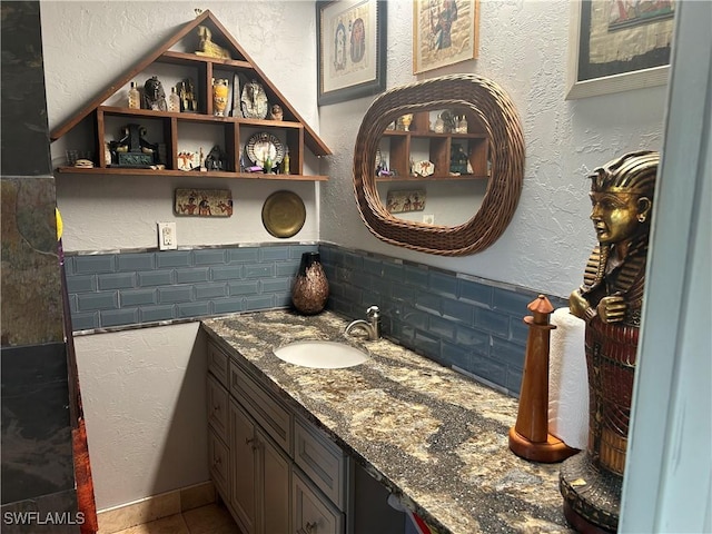 bathroom featuring vanity and tasteful backsplash