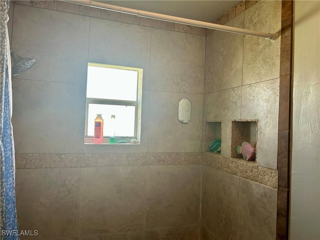 bathroom with tiled shower