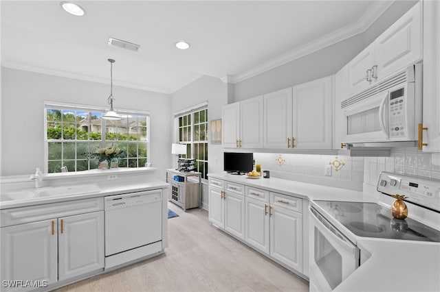 kitchen featuring pendant lighting, white appliances, crown molding, and white cabinets