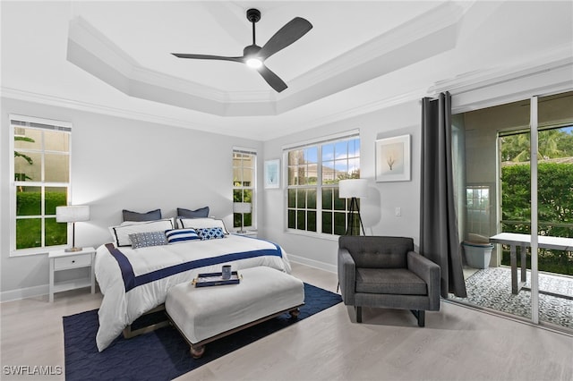 bedroom featuring ornamental molding, access to outside, ceiling fan, a raised ceiling, and light hardwood / wood-style flooring