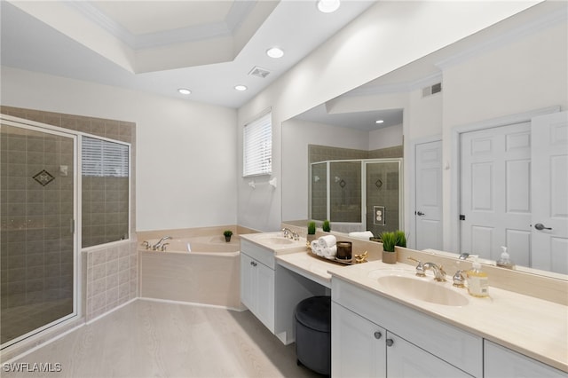 bathroom with crown molding, vanity, shower with separate bathtub, and a raised ceiling