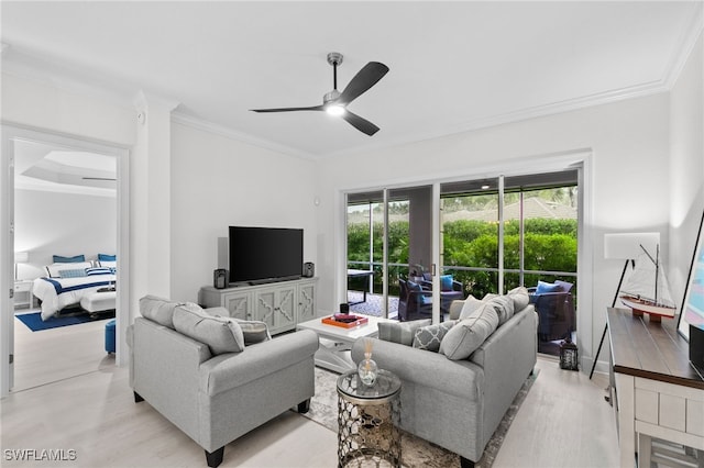 living room with ornamental molding, ceiling fan, and light hardwood / wood-style flooring