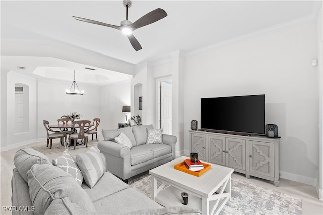 living room featuring ceiling fan with notable chandelier and ornamental molding