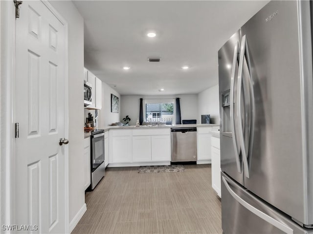 kitchen with recessed lighting, light countertops, visible vents, appliances with stainless steel finishes, and white cabinetry