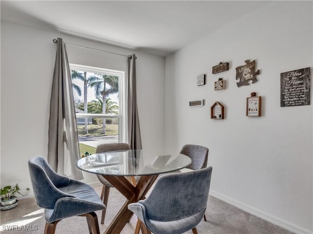 dining area featuring baseboards and carpet flooring