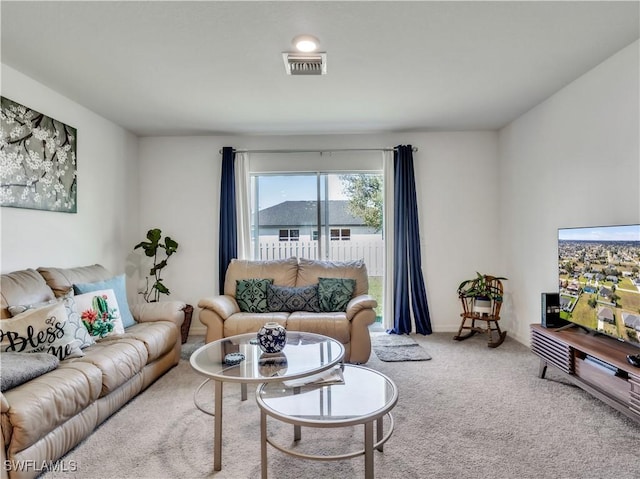 carpeted living area featuring visible vents