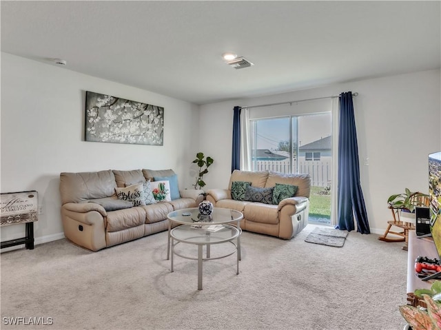 carpeted living area featuring baseboards and visible vents